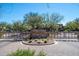 The Villages community entrance with brick pavers, desert landscaping, and decorative wrought-iron gates at 3935 E Rough Rider Rd # 1264, Phoenix, AZ 85050