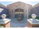 A decorative wrought-iron gate with stone pillars leads to the community at 3935 E Rough Rider Rd # 1264, Phoenix, AZ 85050