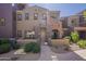 Inviting townhome featuring colorful stucco, gated front patio, and desert landscaping at 3935 E Rough Rider Rd # 1264, Phoenix, AZ 85050
