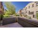 Townhome showcasing desert landscaping, mature trees, and a private outdoor patio at 3935 E Rough Rider Rd # 1264, Phoenix, AZ 85050