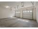 Spacious three car garage featuring finished concrete floors at 3935 E Rough Rider Rd # 1264, Phoenix, AZ 85050