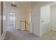 Upstairs hallway boasts neutral walls, carpet, and a laundry closet at 3935 E Rough Rider Rd # 1264, Phoenix, AZ 85050