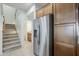 View of kitchen with stainless steel refrigerator and staircase nearby at 3935 E Rough Rider Rd # 1264, Phoenix, AZ 85050
