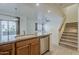 Open kitchen layout with stainless steel dishwasher, granite countertops, and staircase at 3935 E Rough Rider Rd # 1264, Phoenix, AZ 85050