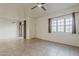 Open living room with tile floors, bright windows, and a back patio entrance at 3935 E Rough Rider Rd # 1264, Phoenix, AZ 85050