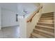 Open living room with carpeted staircase, bright windows, and neutral color palette at 3935 E Rough Rider Rd # 1264, Phoenix, AZ 85050