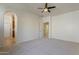 Bright main bedroom featuring a ceiling fan, neutral carpet, and a bathroom ensuite at 3935 E Rough Rider Rd # 1264, Phoenix, AZ 85050