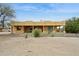 Back of home with desert landscaping, a covered patio, and a view of the blue sky at 40627 N 6Th Ave, Phoenix, AZ 85086