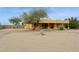 Back of home with desert landscaping, a covered patio, and a beautiful tree at 40627 N 6Th Ave, Phoenix, AZ 85086