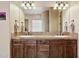 Bathroom vanity featuring double sinks, wooden cabinets, and a neutral colored countertop at 40627 N 6Th Ave, Phoenix, AZ 85086