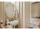Powder room featuring a vessel sink, a round mirror, and a commode at 40627 N 6Th Ave, Phoenix, AZ 85086