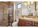 Bathroom featuring a glass shower, wood vanity, and warm neutral colors at 40627 N 6Th Ave, Phoenix, AZ 85086