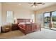 Bedroom with ceiling fan, slider doors, and natural light at 40627 N 6Th Ave, Phoenix, AZ 85086