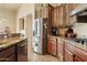 Kitchen with stainless steel appliances, wood cabinets, and granite countertop at 40627 N 6Th Ave, Phoenix, AZ 85086