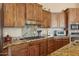 Kitchen with stainless steel appliances, wood cabinets, and granite countertops at 40627 N 6Th Ave, Phoenix, AZ 85086