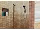 Walk-in shower featuring travertine tile and dual shower heads in an earth tone bathroom at 40627 N 6Th Ave, Phoenix, AZ 85086