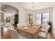 Bright dining room with modern table set and view to a beautifully decorated living room at 4450 E Amberwood Dr, Phoenix, AZ 85048
