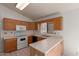 Functional kitchen featuring tile flooring, light wood cabinets, and modern appliances at 4450 E Amberwood Dr, Phoenix, AZ 85048