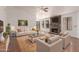 Bright living room with stone fireplace, large windows, and hardwood floors at 4450 E Amberwood Dr, Phoenix, AZ 85048