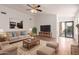 Comfortable living room with plush beige sofa, stylish rug, and modern entertainment center at 4450 E Amberwood Dr, Phoenix, AZ 85048
