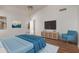 Spacious bedroom with serene blue decor, entertainment center, and natural light at 4450 E Amberwood Dr, Phoenix, AZ 85048