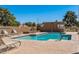 Community pool area featuring crystal clear water, lounge chairs for relaxing, and a secure gated perimeter at 4450 E Amberwood Dr, Phoenix, AZ 85048