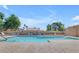 Community pool area featuring crystal clear water, lounge chairs for relaxing, and a secure gated perimeter at 4450 E Amberwood Dr, Phoenix, AZ 85048