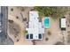 Aerial view of a modern home featuring solar panels, a swimming pool and outdoor patio at 5033 E Turquoise Ave, Paradise Valley, AZ 85253