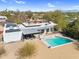 Modern desert home featuring a pool, solar panels, and mountain views at 5033 E Turquoise Ave, Paradise Valley, AZ 85253
