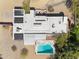 Aerial view of a modern home with solar panels, pool, and outdoor seating area at 5033 E Turquoise Ave, Paradise Valley, AZ 85253