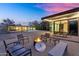 Stylish backyard with fire pit, dining area, and a modern glass house, perfect for entertaining at 5033 E Turquoise Ave, Paradise Valley, AZ 85253