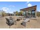 Scenic backyard featuring a desert landscape, covered patio, pool, and outdoor seating area at 5033 E Turquoise Ave, Paradise Valley, AZ 85253