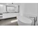 Clean bathroom featuring a soaking tub, modern fixtures, and neutral decor at 5033 E Turquoise Ave, Paradise Valley, AZ 85253
