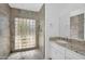Modern bathroom featuring a glass block window in the shower and granite countertops at 5033 E Turquoise Ave, Paradise Valley, AZ 85253