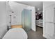 Bathroom featuring a large tub, glass shower, and walk-in closet at 5033 E Turquoise Ave, Paradise Valley, AZ 85253