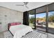 Modern bedroom boasts concrete walls, patio access, and a serene view of the outdoor living space at 5033 E Turquoise Ave, Paradise Valley, AZ 85253