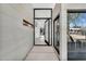 Modern entryway with pivoting glass front door, and beautiful interior and exterior views at 5033 E Turquoise Ave, Paradise Valley, AZ 85253