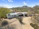 A contemporary white home with desert landscaping, a large cactus and a winding driveway at 5033 E Turquoise Ave, Paradise Valley, AZ 85253