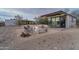 Exterior view of modern home with pool, desert landscape, seating area with a firepit, and a glass-walled structure at 5033 E Turquoise Ave, Paradise Valley, AZ 85253