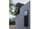 Architectural detail of exterior brick wall showcasing custom steel-framed windows and a cantilevered glass element at 5033 E Turquoise Ave, Paradise Valley, AZ 85253