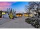 Stunning desert home featuring modern architecture and native landscaping, lit beautifully at dusk at 5033 E Turquoise Ave, Paradise Valley, AZ 85253
