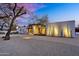Nighttime view of a modern home with desert landscaping and unique outdoor lighting at 5033 E Turquoise Ave, Paradise Valley, AZ 85253