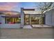 Striking modern home with a landscaped entry, clean lines, and outdoor seating area at 5033 E Turquoise Ave, Paradise Valley, AZ 85253