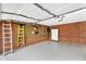 Well-organized garage featuring epoxy flooring, brick wall, and storage solutions at 5033 E Turquoise Ave, Paradise Valley, AZ 85253