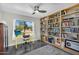 Inviting home office with built-in bookshelves and a large window with views of desert landscape at 5033 E Turquoise Ave, Paradise Valley, AZ 85253