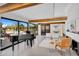 Spacious living room with beamed ceilings, a grand piano, and large windows at 5033 E Turquoise Ave, Paradise Valley, AZ 85253