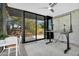 Spacious living room with floor-to-ceiling windows showcasing an outdoor view and a ceiling fan at 5033 E Turquoise Ave, Paradise Valley, AZ 85253