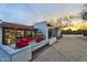 Chic patio with colorful seating, a modern water feature, and sunset views at 5033 E Turquoise Ave, Paradise Valley, AZ 85253