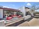 Stylish outdoor patio with red seating, a unique water feature, and modern design elements at 5033 E Turquoise Ave, Paradise Valley, AZ 85253