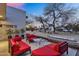 Charming outdoor patio with red couches, coffee table and linear fireplace at 5033 E Turquoise Ave, Paradise Valley, AZ 85253